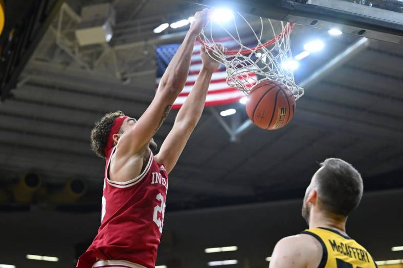 Jan 5, 2023; Iowa City, Iowa, USA; Indiana Hoosiers forward Race Thompson (25) completes a slam dunk over Iowa Hawkeyes guard Connor McCaffery (30) during the first half at Carver-Hawkeye Arena. Mandatory Credit: Jeffrey Becker-USA TODAY Sports