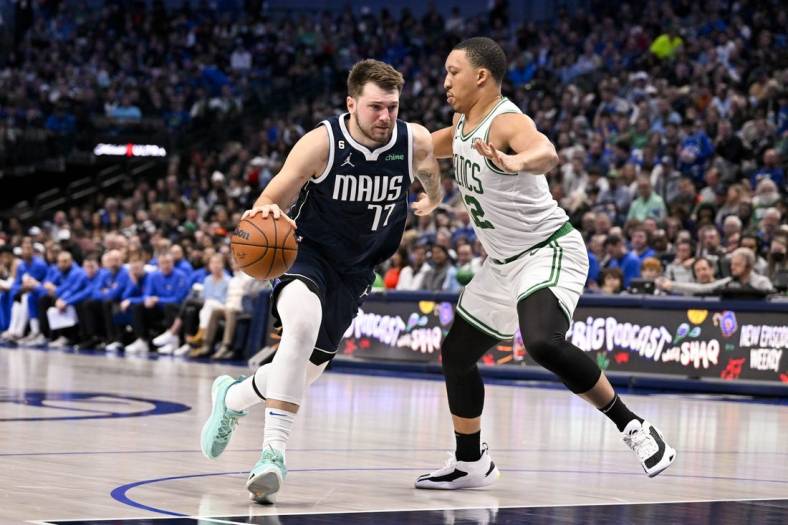 Jan 5, 2023; Dallas, Texas, USA; Dallas Mavericks guard Luka Doncic (77) drives to the basket against Boston Celtics forward Grant Williams (12) during the second half at the American Airlines Center. Mandatory Credit: Jerome Miron-USA TODAY Sports
