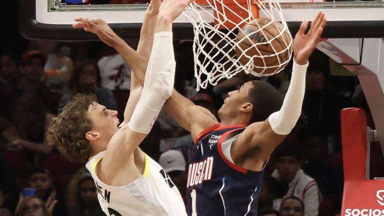 Jan 5, 2023; Houston, Texas, USA; Utah Jazz forward Lauri Markkanen (23) dunks against Houston Rockets forward Jabari Smith Jr. (1) in the second half at Toyota Center. Mandatory Credit: Thomas Shea-USA TODAY Sports