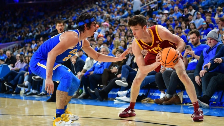 Jan 5, 2023; Los Angeles, California, USA; Southern California Trojans guard Drew Peterson (13) moves the ball against UCLA Bruins guard Jaime Jaquez Jr. (24) during the second half at Pauley Pavilion. Mandatory Credit: Gary A. Vasquez-USA TODAY Sports