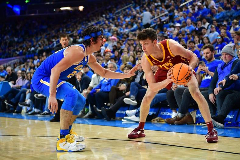 Jan 5, 2023; Los Angeles, California, USA; Southern California Trojans guard Drew Peterson (13) moves the ball against UCLA Bruins guard Jaime Jaquez Jr. (24) during the second half at Pauley Pavilion. Mandatory Credit: Gary A. Vasquez-USA TODAY Sports