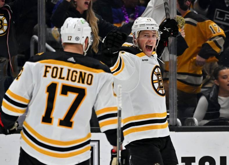 Jan 5, 2023; Los Angeles, California, USA;  Boston Bruins left wing Nick Foligno (17) congratulates center Trent Frederic (11) after a goal in the third period against the Los Angeles Kings at Crypto.com Arena. Mandatory Credit: Jayne Kamin-Oncea-USA TODAY Sports
