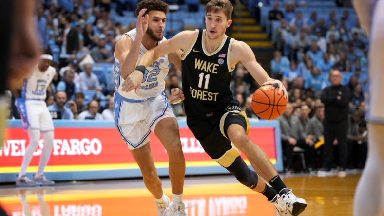 Jan 4, 2023; Chapel Hill, North Carolina, USA; Wake Forest Demon Deacons forward Andrew Carr (11) with the ball as North Carolina Tar Heels forward Pete Nance (32) defends in the first half at Dean E. Smith Center. Mandatory Credit: Bob Donnan-USA TODAY Sports