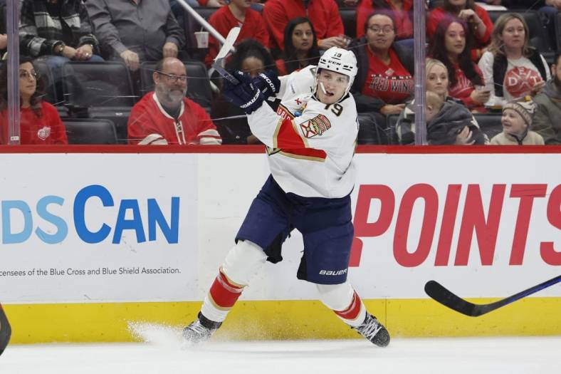Jan 6, 2023; Detroit, Michigan, USA;  Florida Panthers left wing Matthew Tkachuk (19) takes a shot in the first period against the Detroit Red Wings at Little Caesars Arena. Mandatory Credit: Rick Osentoski-USA TODAY Sports