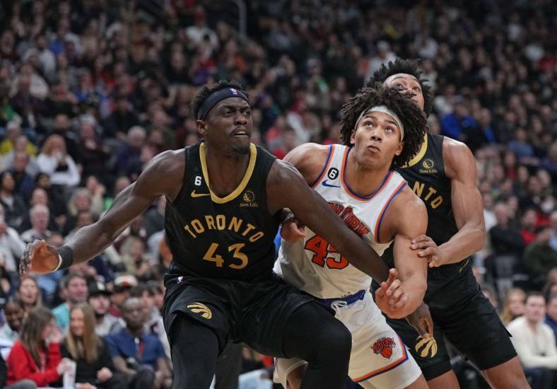 Jan 6, 2023; Toronto, Ontario, CAN; New York Knicks center Jericho Sims (45) battles for the rebound with Toronto Raptors forward Pascal Siakam (43) and Toronto Raptors forward Scottie Barnes (4) during the second quarter at Scotiabank Arena. Mandatory Credit: Nick Turchiaro-USA TODAY Sports