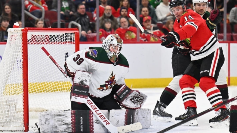 Jan 6, 2023; Chicago, Illinois, USA;  Arizona Coyotes goaltender Connor Ingram (39) makes a save as Chicago Blackhawks forward Jonathan Toews (19) looks for the rebound in the first period at United Center. Mandatory Credit: Jamie Sabau-USA TODAY Sports