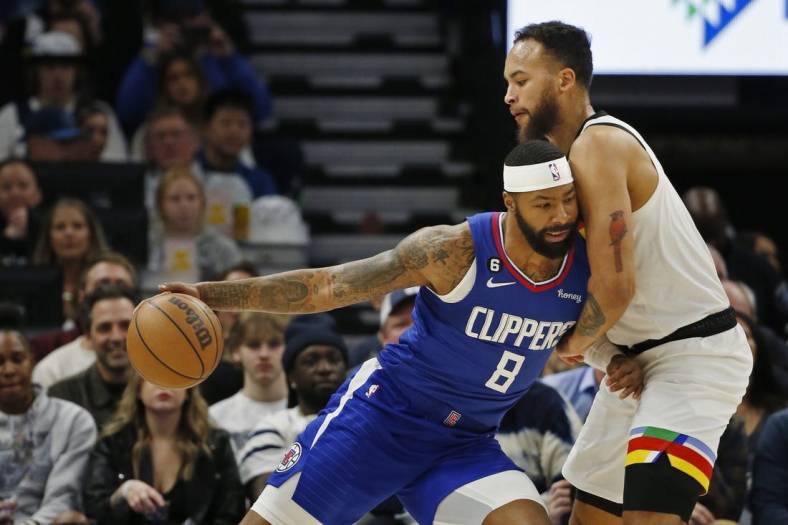 Jan 6, 2023; Minneapolis, Minnesota, USA; Los Angeles Clippers forward Marcus Morris (8) works against Minnesota Timberwolves center Rudy Gobert (27) in the first quarter at Target Center. Mandatory Credit: Bruce Kluckhohn-USA TODAY Sports