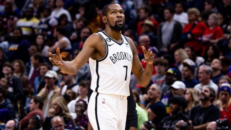 Jan 6, 2023; New Orleans, Louisiana, USA;  Brooklyn Nets forward Kevin Durant (7) reacts to guard Kyrie Irving (11) making a three point basket against the New Orleans Pelicans during the second half at Smoothie King Center. Mandatory Credit: Stephen Lew-USA TODAY Sports