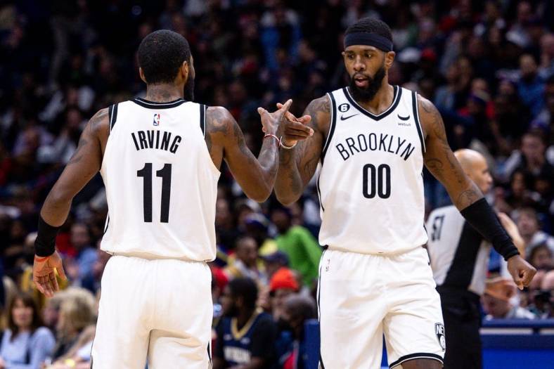 Jan 6, 2023; New Orleans, Louisiana, USA;  Brooklyn Nets guard Kyrie Irving (11) and forward Royce O'Neale (00) react to a play against the New Orleans Pelicans during the second half at Smoothie King Center. Mandatory Credit: Stephen Lew-USA TODAY Sports