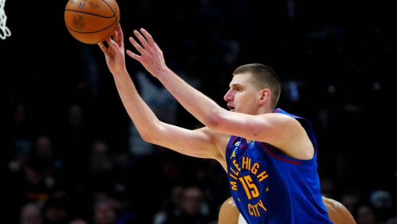 Jan 6, 2023; Denver, Colorado, USA; Denver Nuggets center Nikola Jokic (15) passes the ball in the second half against the Cleveland Cavaliers at Ball Arena. Mandatory Credit: Ron Chenoy-USA TODAY Sports