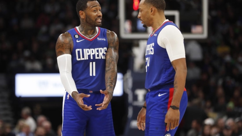 Jan 6, 2023; Minneapolis, Minnesota, USA; Los Angeles Clippers guard John Wall (11) and guard Norman Powell (24) discuss strategy as they play the Minnesota Timberwolves in the fourth quarter at Target Center. Mandatory Credit: Bruce Kluckhohn-USA TODAY Sports