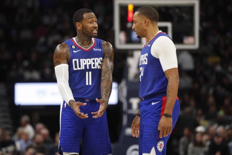 Jan 6, 2023; Minneapolis, Minnesota, USA; Los Angeles Clippers guard John Wall (11) and guard Norman Powell (24) discuss strategy as they play the Minnesota Timberwolves in the fourth quarter at Target Center. Mandatory Credit: Bruce Kluckhohn-USA TODAY Sports