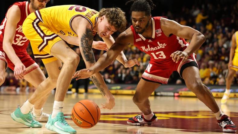 Jan 7, 2023; Minneapolis, Minnesota, USA; Minnesota Golden Gophers center Treyton Thompson (42) and Nebraska Cornhuskers forward Derrick Walker (13) dive for the ball during the first half at Williams Arena. Mandatory Credit: Matt Krohn-USA TODAY Sports