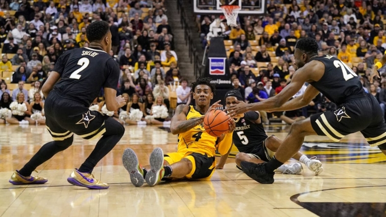 Jan 7, 2023; Columbia, Missouri, USA; Missouri Tigers guard DeAndre Gholston (4) and Vanderbilt Commodores guard Ezra Manjon (5) fight for a loose ball during the first half at Mizzou Arena. Mandatory Credit: Denny Medley-USA TODAY Sports