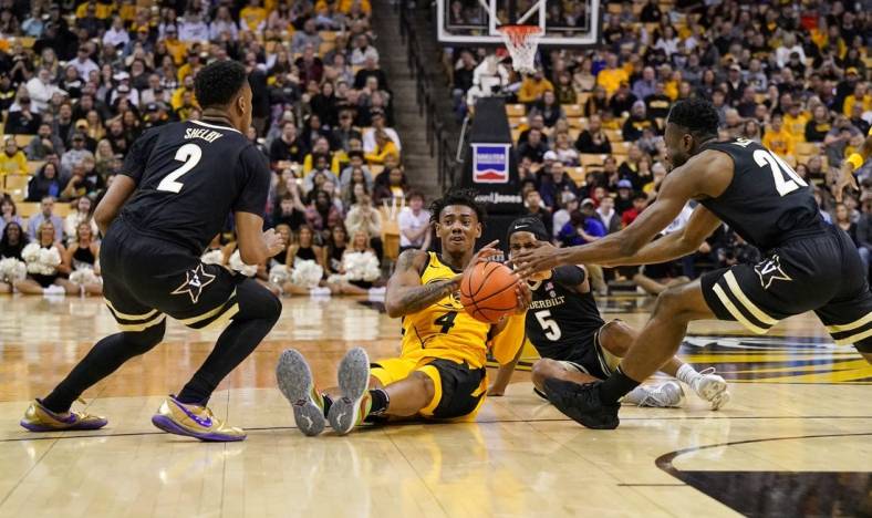 Jan 7, 2023; Columbia, Missouri, USA; Missouri Tigers guard DeAndre Gholston (4) and Vanderbilt Commodores guard Ezra Manjon (5) fight for a loose ball during the first half at Mizzou Arena. Mandatory Credit: Denny Medley-USA TODAY Sports