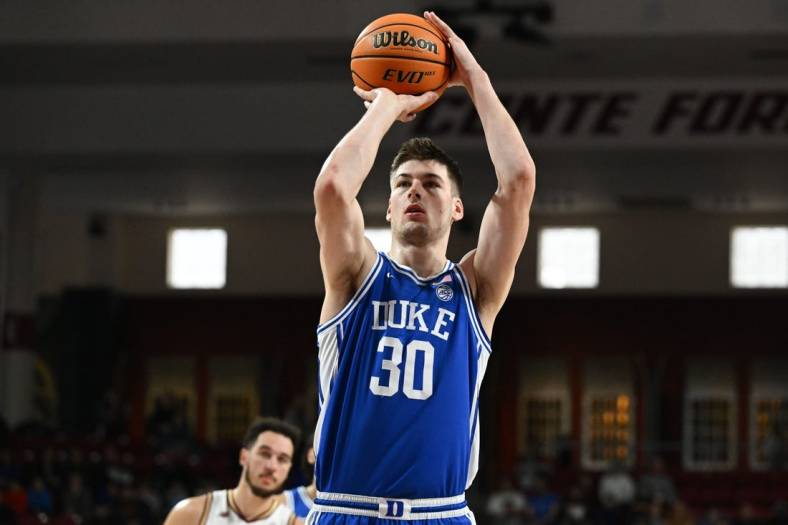Jan 7, 2023; Chestnut Hill, Massachusetts, USA; Duke Blue Devils center Kyle Filipowski (30) attempts a free-throw against the Boston College Eagles during the first half at the Conte Forum. Mandatory Credit: Brian Fluharty-USA TODAY Sports