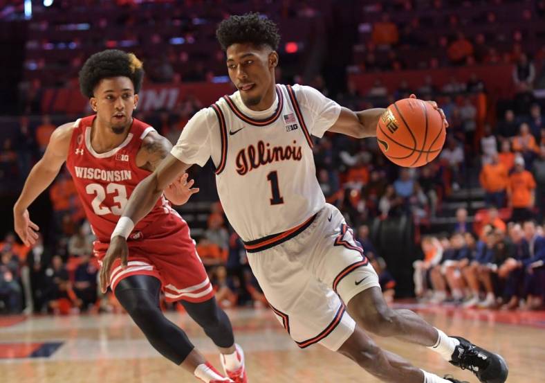 Jan 7, 2023; Champaign, Illinois, USA;  Illinois Fighting Illini guard Sencire Harris (1) drives the ball past Wisconsin Badgers guard Chucky Hepburn (23) during the first half at State Farm Center. Mandatory Credit: Ron Johnson-USA TODAY Sports