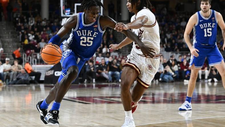 Jan 7, 2023; Chestnut Hill, Massachusetts, USA; Duke Blue Devils forward Mark Mitchell (25) drives to the basket against Boston College Eagles guard DeMarr Langford Jr. (5) during the second half at the Conte Forum. Mandatory Credit: Brian Fluharty-USA TODAY Sports