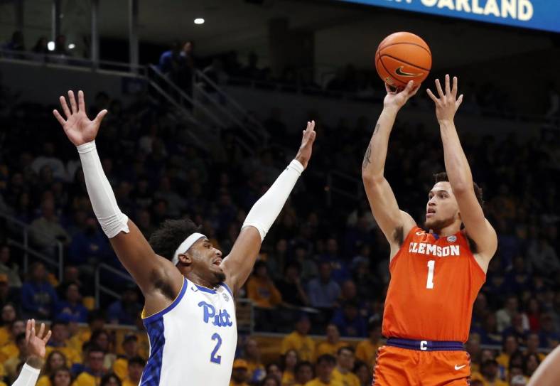 Jan 7, 2023; Pittsburgh, Pennsylvania, USA;  Clemson Tigers guard Chase Hunter (1) shoots against Pittsburgh Panthers forward Blake Hinson (2) during the first half at the Petersen Events Center. Mandatory Credit: Charles LeClaire-USA TODAY Sports