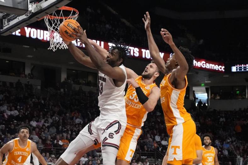 Jan 7, 2023; Columbia, South Carolina, USA; South Carolina Gamecocks forward Josh Gray (33) tries to hang onto the rebound pressured by Tennessee Volunteers forward Uros Plavsic (33) during the first half at Colonial Life Arena. Mandatory Credit: Jim Dedmon-USA TODAY Sports