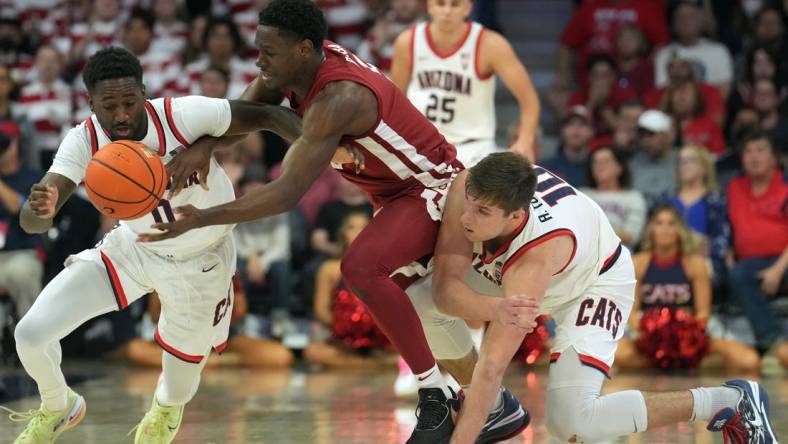 Jan 7, 2023; Tucson, Arizona, USA; Arizona Wildcats guard Courtney Ramey (0) and Arizona Wildcats center Oumar Ballo (11) defend against Washington State Cougars guard TJ Bamba (5) during the second half at McKale Center. Mandatory Credit: Joe Camporeale-USA TODAY Sports