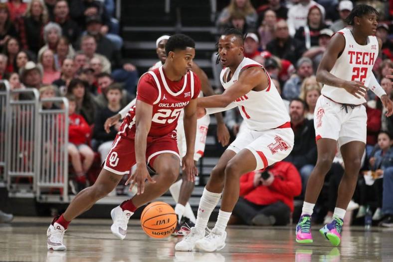 Jan 7, 2023; Lubbock, Texas, USA;  Oklahoma Sooners guard Brant Sherfield (25) dribbles the ball against Texas Tech Red Raiders guard Lamar Washington (1) in the first half at United Supermarkets Arena. Mandatory Credit: Michael C. Johnson-USA TODAY Sports