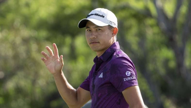 January 7, 2023; Maui, Hawaii, USA; Collin Morikawa acknowledges the crowd after making his putt on the 18th hole during the third round of the Sentry Tournament of Champions golf tournament at Kapalua Resort - The Plantation Course. Mandatory Credit: Kyle Terada-USA TODAY Sports