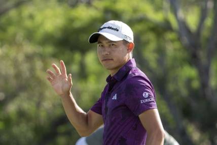 January 7, 2023; Maui, Hawaii, USA; Collin Morikawa acknowledges the crowd after making his putt on the 18th hole during the third round of the Sentry Tournament of Champions golf tournament at Kapalua Resort - The Plantation Course. Mandatory Credit: Kyle Terada-USA TODAY Sports