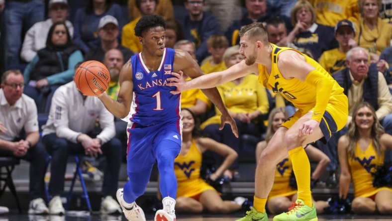 Jan 7, 2023; Morgantown, West Virginia, USA; Kansas Jayhawks guard Joseph Yesufu (1) passes the ball while being defended by West Virginia Mountaineers guard Erik Stevenson (10) during the second half at WVU Coliseum. Mandatory Credit: Ben Queen-USA TODAY Sports