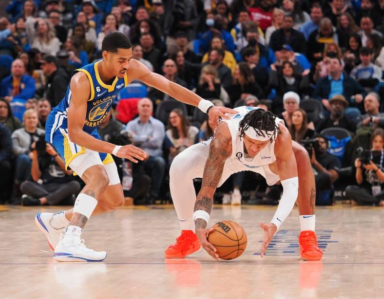 Jan 7, 2023; San Francisco, California, USA; Orlando Magic power forward Paolo Banchero (right) gathers the ball against Golden State Warriors shooting guard Jordan Poole (3) during the second quarter at Chase Center. Mandatory Credit: Kelley L Cox-USA TODAY Sports