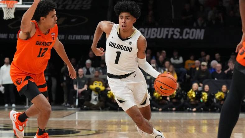 Jan 7, 2023; Boulder, Colorado, USA; Colorado Buffaloes guard Julian Hammond III (1) dribbles past Oregon State Beavers forward Michael Rataj (12) in the first half at CU Events Center. Mandatory Credit: Ron Chenoy-USA TODAY Sports