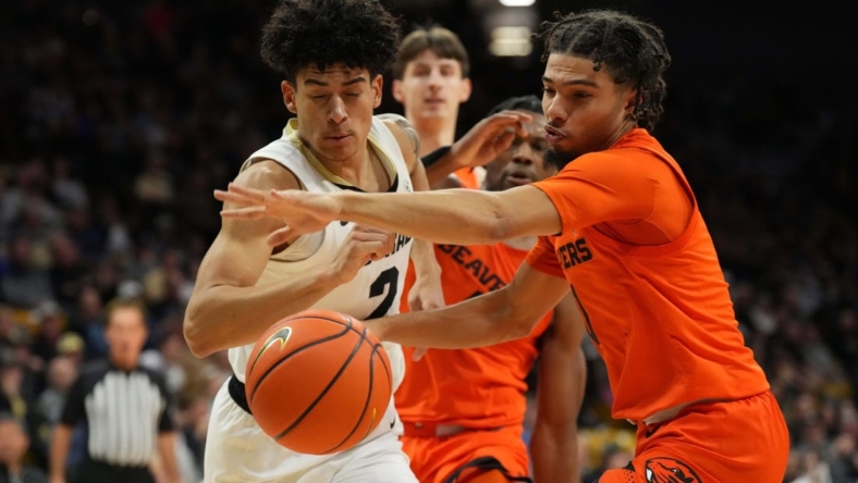 Jan 7, 2023; Boulder, Colorado, USA; Oregon State Beavers guard Jordan Pope (0) knocks the ball away from Colorado Buffaloes guard KJ Simpson (2) in the first half at CU Events Center. Mandatory Credit: Ron Chenoy-USA TODAY Sports