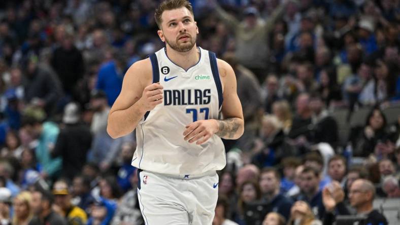 Jan 7, 2023; Dallas, Texas, USA; Dallas Mavericks guard Luka Doncic (77) motions to the crown as he runs back up the court after making an assist against the New Orleans Pelicans during the second half at the American Airlines Center. Mandatory Credit: Jerome Miron-USA TODAY Sports