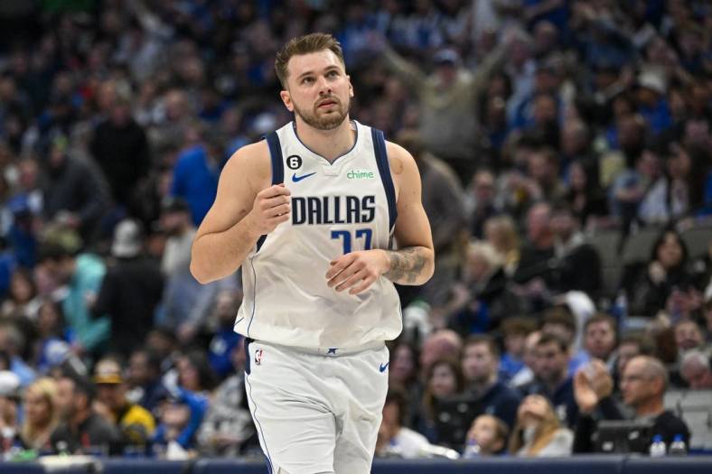 Jan 7, 2023; Dallas, Texas, USA; Dallas Mavericks guard Luka Doncic (77) motions to the crown as he runs back up the court after making an assist against the New Orleans Pelicans during the second half at the American Airlines Center. Mandatory Credit: Jerome Miron-USA TODAY Sports