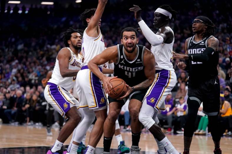 Jan 7, 2023; Sacramento, California, USA; Sacramento Kings forward Trey Lyles (41) holds onto the ball between Los Angeles Lakers guard Max Christie (10) and forward Wenyen Gabriel (35) in the first quarter at the Golden 1 Center. Mandatory Credit: Cary Edmondson-USA TODAY Sports