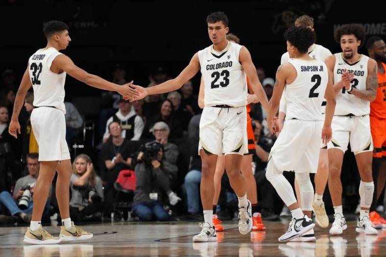 Jan 7, 2023; Boulder, Colorado, USA; Colorado Buffaloes forward Tristan da Silva (23) and guard Nique Clifford (32) and guard KJ Simpson (2) celebrate a score in the second half against the Oregon State Beavers at CU Events Center. Mandatory Credit: Ron Chenoy-USA TODAY Sports