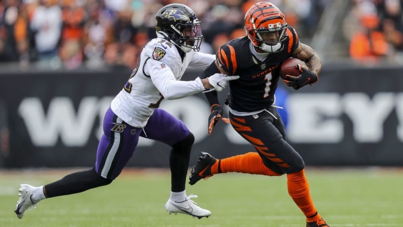 Jan 8, 2023; Cincinnati, Ohio, USA; Cincinnati Bengals wide receiver Ja'Marr Chase (1) runs with the ball against Baltimore Ravens safety Marcus Williams (32) in the first half at Paycor Stadium. Mandatory Credit: Katie Stratman-USA TODAY Sports