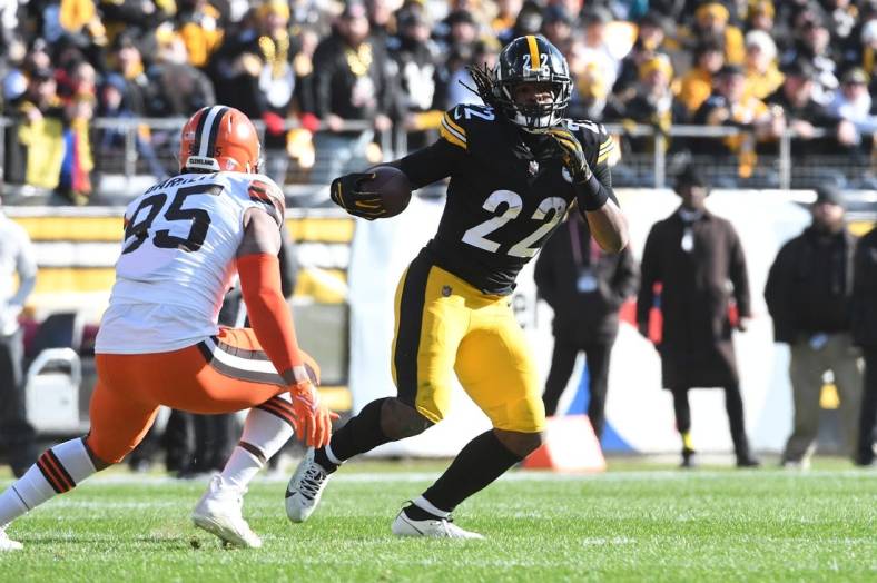 Jan 8, 2023; Pittsburgh, Pennsylvania, USA;  Pittsburgh Steelers runninmg back Najee Harris (22) runs from Cleveland Browns defensive end Myles Garrett (95) during the first quarter at Acrisure Stadium. Mandatory Credit: Philip G. Pavely-USA TODAY Sports