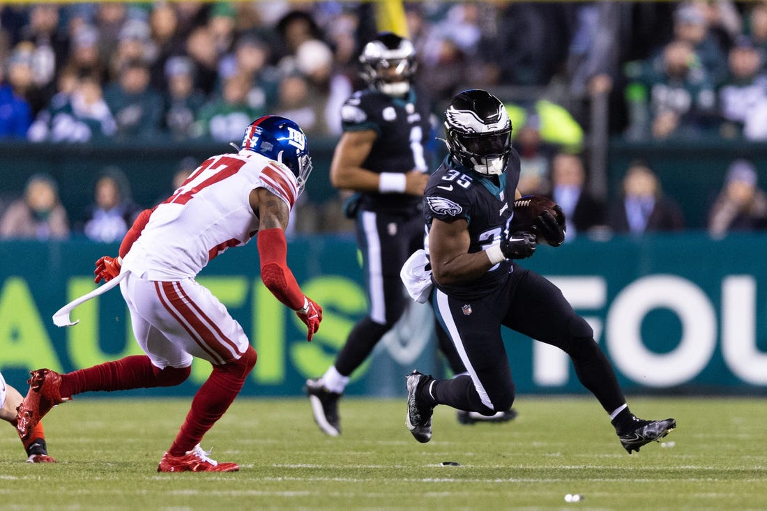 Jan 8, 2023; Philadelphia, Pennsylvania, USA; Philadelphia Eagles running back Boston Scott (35) runs with the ball against New York Giants cornerback Jason Pinnock (27) during the second quarter at Lincoln Financial Field. Mandatory Credit: Bill Streicher-USA TODAY Sports