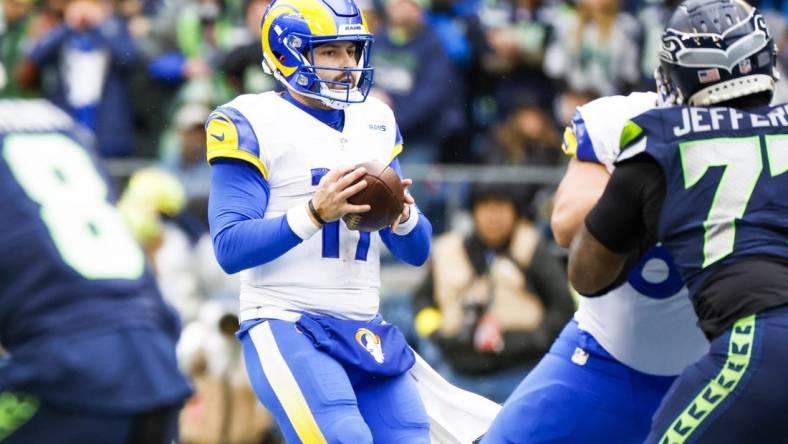 Jan 8, 2023; Seattle, Washington, USA; Los Angeles Rams quarterback Baker Mayfield (17) drops back to pass against the Seattle Seahawks during the second quarter at Lumen Field. Mandatory Credit: Joe Nicholson-USA TODAY Sports