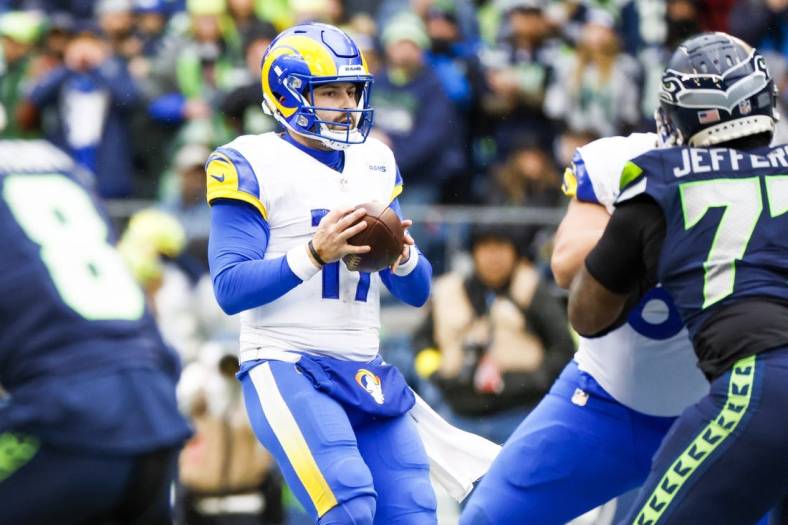 Jan 8, 2023; Seattle, Washington, USA; Los Angeles Rams quarterback Baker Mayfield (17) drops back to pass against the Seattle Seahawks during the second quarter at Lumen Field. Mandatory Credit: Joe Nicholson-USA TODAY Sports