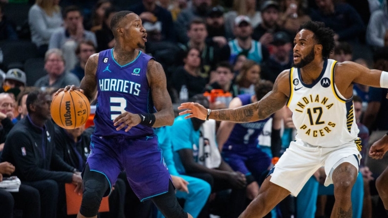 Jan 8, 2023; Indianapolis, Indiana, USA; Charlotte Hornets guard Terry Rozier (3) dribbles the ball while Indiana Pacers forward Oshae Brissett (12) defends in the second quarter at Gainbridge Fieldhouse. Mandatory Credit: Trevor Ruszkowski-USA TODAY Sports