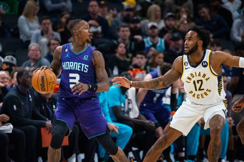 Jan 8, 2023; Indianapolis, Indiana, USA; Charlotte Hornets guard Terry Rozier (3) dribbles the ball while Indiana Pacers forward Oshae Brissett (12) defends in the second quarter at Gainbridge Fieldhouse. Mandatory Credit: Trevor Ruszkowski-USA TODAY Sports