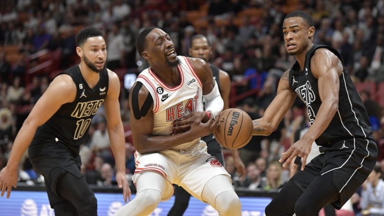Jan 8, 2023; Miami, Florida, USA;  Miami Heat center Bam Adebayo (13) loses the ball in front of Brooklyn Nets center Nic Claxton (13) during the first quarter of their game at FTX Arena. Mandatory Credit: Michael Laughlin-USA TODAY Sports