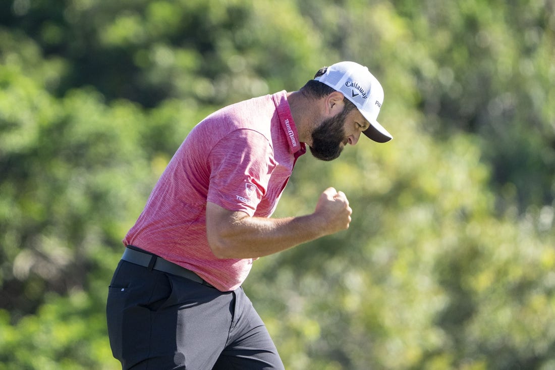 January 8, 2023; Maui, Hawaii, USA; Jon Rahm celebrates after making his putt on the 18th hole during the final round of the Sentry Tournament of Champions golf tournament at Kapalua Resort - The Plantation Course. Mandatory Credit: Kyle Terada-USA TODAY Sports