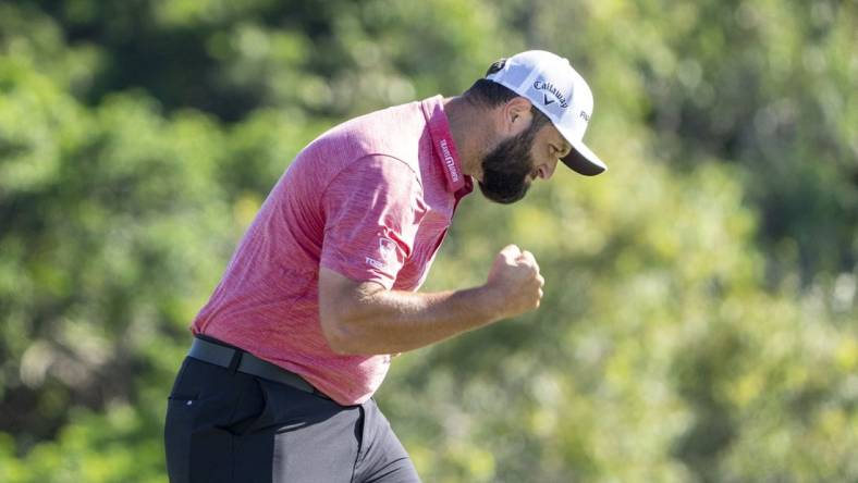 January 8, 2023; Maui, Hawaii, USA; Jon Rahm celebrates after making his putt on the 18th hole during the final round of the Sentry Tournament of Champions golf tournament at Kapalua Resort - The Plantation Course. Mandatory Credit: Kyle Terada-USA TODAY Sports