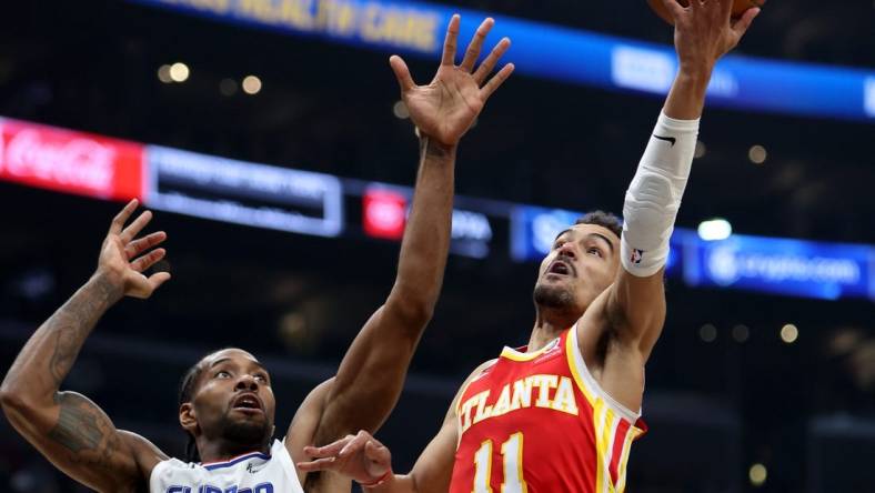 Jan 8, 2023; Los Angeles, California, USA;  Atlanta Hawks guard Trae Young (11) shoots the ball against Los Angeles Clippers forward Kawhi Leonard (2) during the second quarter at Crypto.com Arena. Mandatory Credit: Kiyoshi Mio-USA TODAY Sports