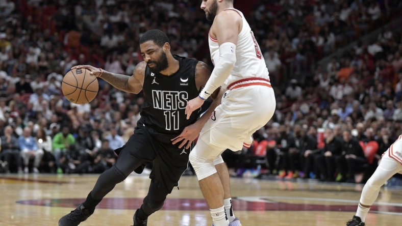 Jan 8, 2023; Miami, Florida, USA;  Brooklyn Nets guard Kyrie Irving (11) bumps into Miami Heat guard Max Strus (31) during the fourth quarter at FTX Arena. Mandatory Credit: Michael Laughlin-USA TODAY Sports