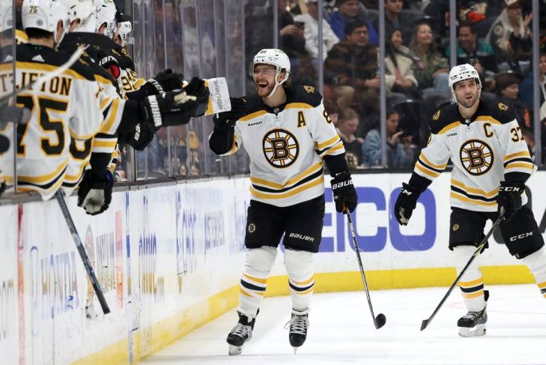 Jan 8, 2023; Anaheim, California, USA; Boston Bruins right wing David Pastrnak (88) celebrates his second goal with teammates during the second period against the Anaheim Ducks at Honda Center. Mandatory Credit: Jason Parkhurst-USA TODAY Sports