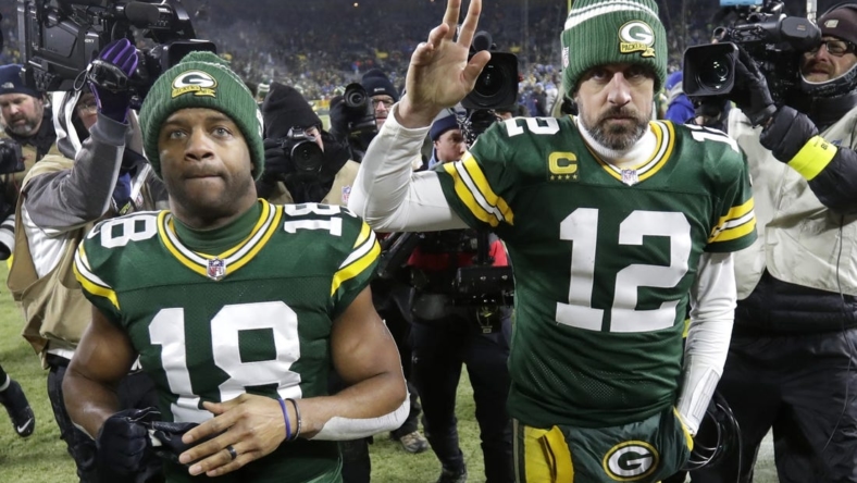 Jan 8, 2023; Green Bay, Wisconsin, USA; Green Bay Packers wide receiver Randall Cobb (18) and quarterback Aaron Rodgers (12) leave the field together after losing to the Detroit Lions at Lambeau Field. Mandatory Credit: Dan Powers/Appleton Post-Crescent via USA TODAY NETWORK